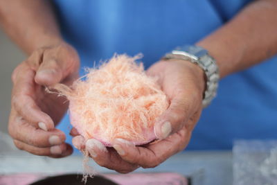 Midsection of man holding sponge