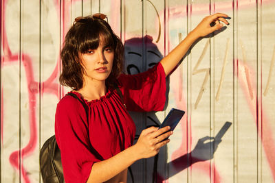 Portrait of young woman using mobile phone