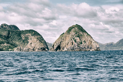 Scenic view of sea and mountains against sky