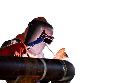 Low angle view of man lying down against white background