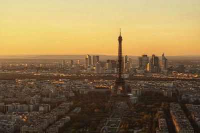 Aerial view of buildings in city during sunset