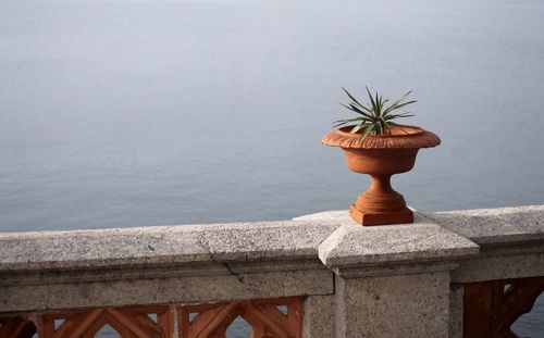 Close-up of railing by sea against sky