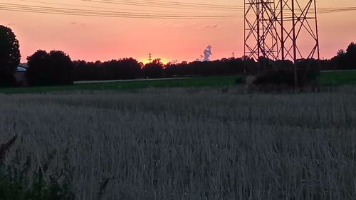 Scenic view of field against sky at sunset