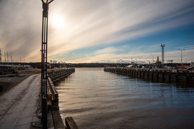 Pier over sea against sky during sunset