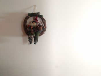 Close-up of christmas decoration hanging on white background