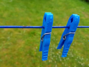 Close-up of clothespins hanging on clothesline