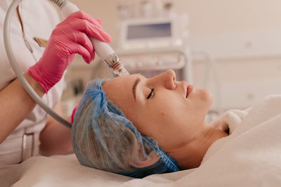 Close-up of doctor examining patient in hospital