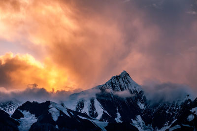 Scenic view of snowcapped mountains against sky during sunset