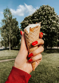 Cropped hand of person holding ice cream cone