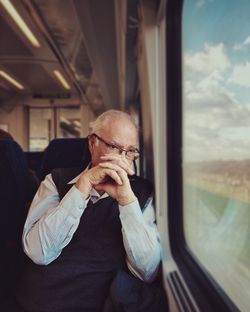 Rear view of man traveling in train