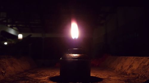 Close-up of illuminated lamp on table