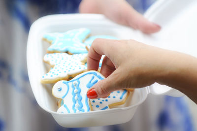 Cropped hand of woman holding gingerbread cookie