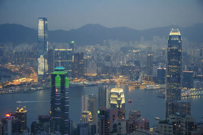 Aerial view of illuminated buildings in city against sky