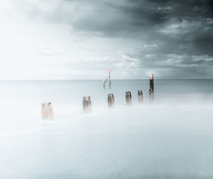 People at beach against sky