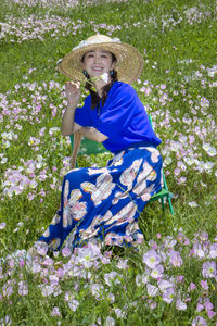 Portrait of a smiling young woman in flower field