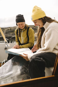 Women looking at map on boat
