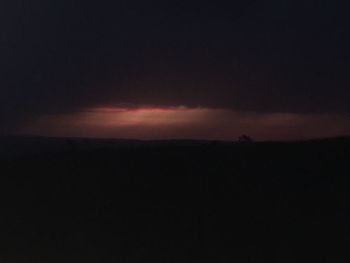 Silhouette landscape against sky at sunset