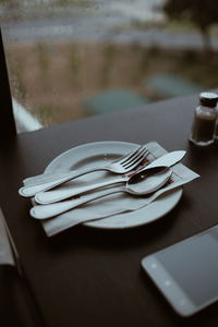 High angle view of silverware on plate at table
