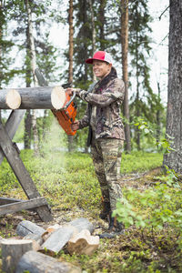 Woman using chainsaw