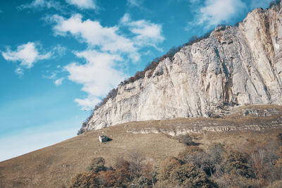 Low angle view of rock formations against sky