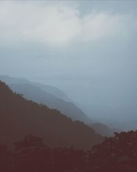 Scenic view of mountains against cloudy sky