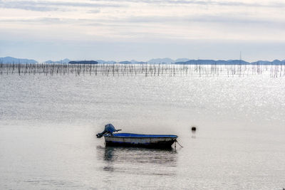 Boats in sea against sky