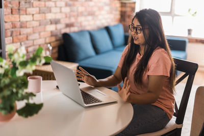 Young woman using laptop at home