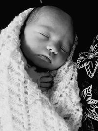 Close-up of baby boy sleeping on bed at home