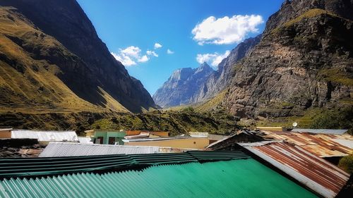 Panoramic view of buildings and mountains against sky