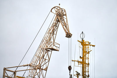 Massive harbor crane in port. heavy load dockside crane in seaport, cargo container ship terminal