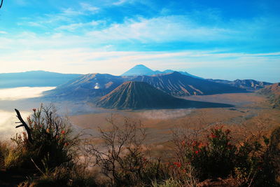 Scenic view of mountains against cloudy sky