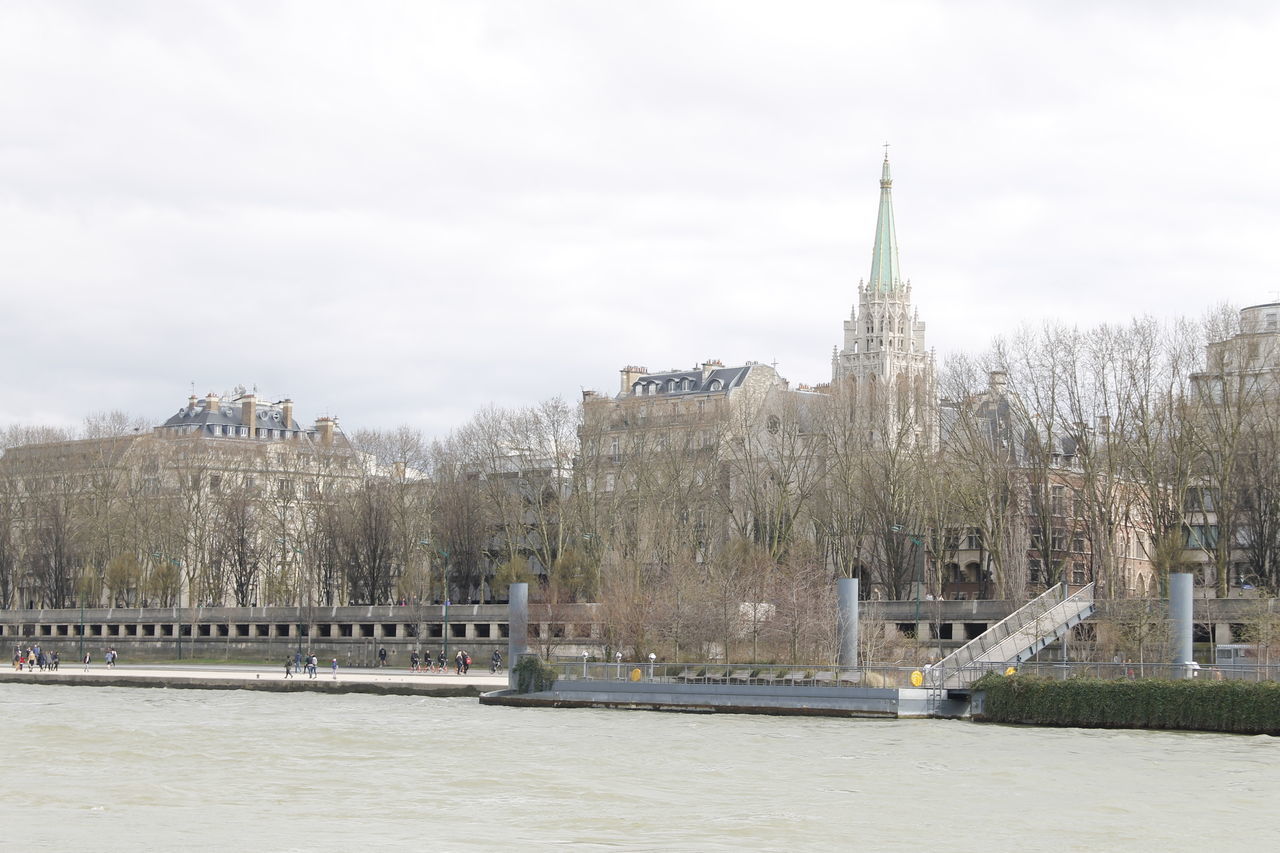 VIEW OF BUILDINGS BY RIVER AGAINST SKY