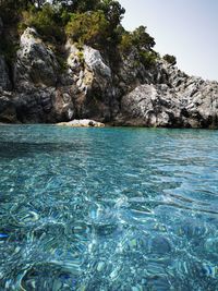 Scenic view of sea against rock formation