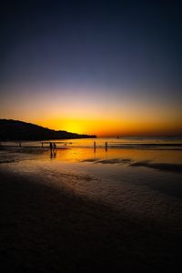 Scenic view of beach against sky during sunset