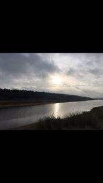Reflection of clouds in sea at sunset