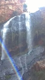 Scenic view of waterfall against sky