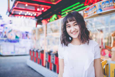 Beautiful asian girl in an amusement park, smiling