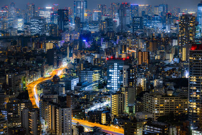 Aerial view of illuminated city buildings at night