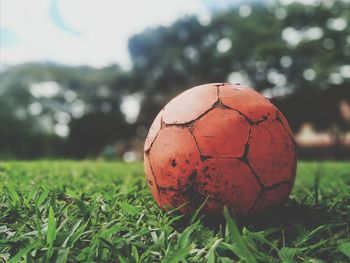 Close-up of dirty soccer ball on land