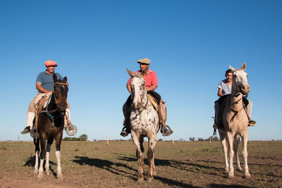 People riding horse in south america