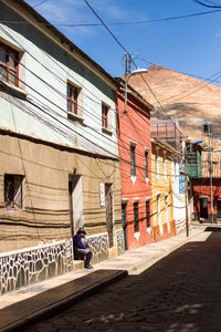 Street amidst buildings against sky in city