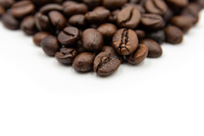 Close-up of coffee beans against white background