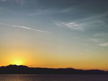 Scenic view of silhouette mountains against sky during sunset