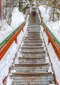 High angle view of snow covered footbridge