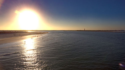 Scenic view of sea against clear sky at sunset