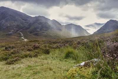 Scenic view of mountains against cloudy sky