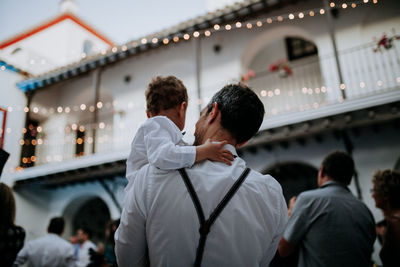 Rear view of friends standing outdoors