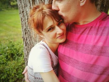 Portrait of couple kissing outdoors