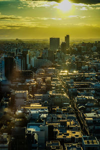 High angle view of illuminated buildings against sky during sunset