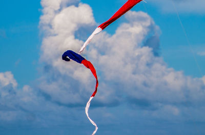 Low angle view of airplane flying against sky